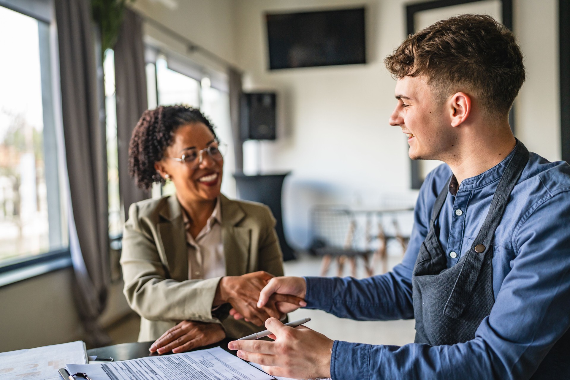 young man entrepreneur handshake with female financial adviser
