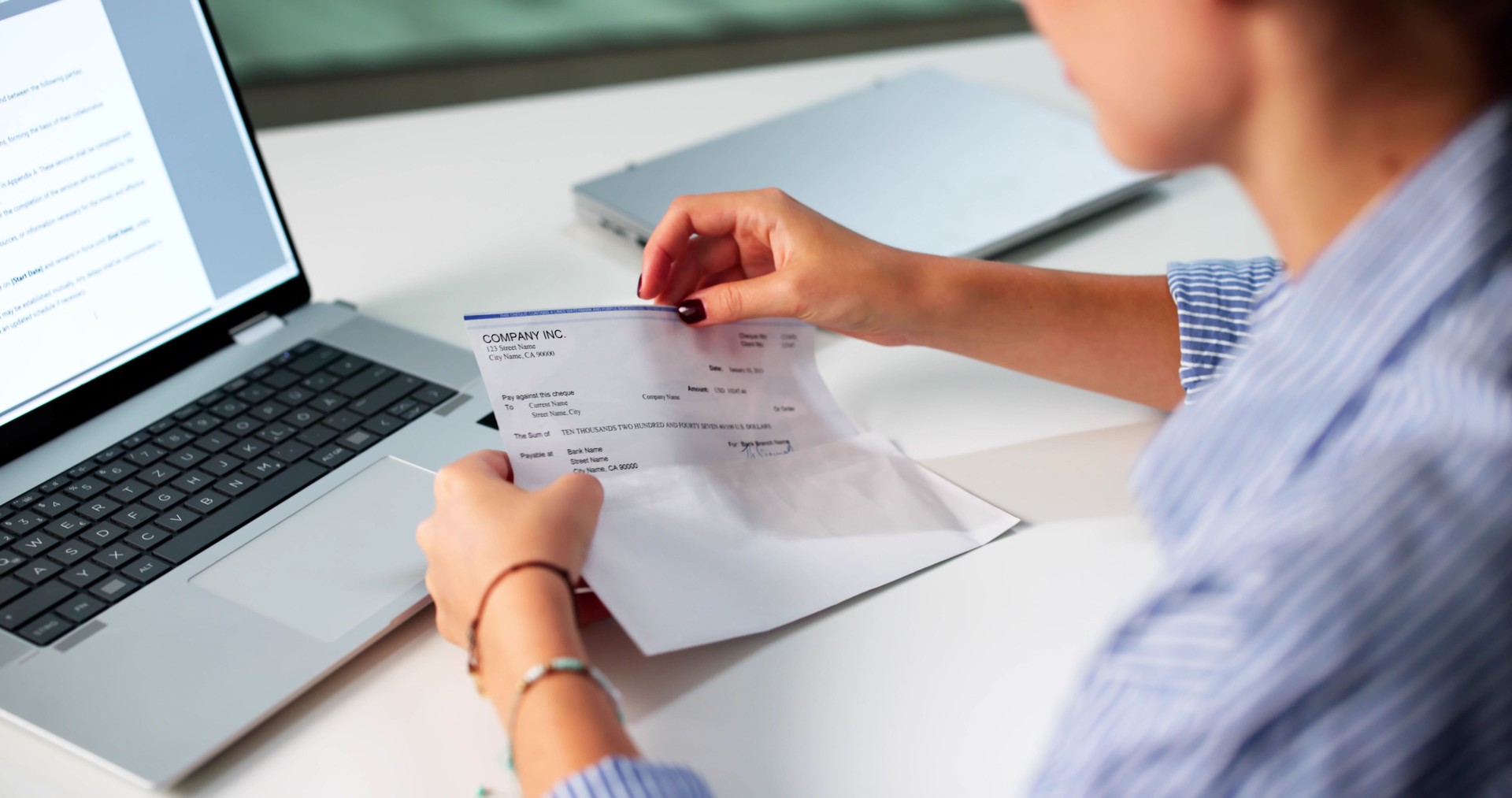 Woman In Office Managing Payroll Compensation Check Envelope